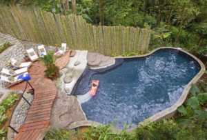 An overhead view of the lagoon pool shows the private tropical jungle setting and its immense size.