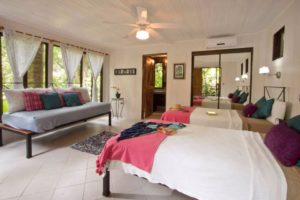 The lower level bedroom in the jungle guest house sleeps 3 people on 3 single beds.
