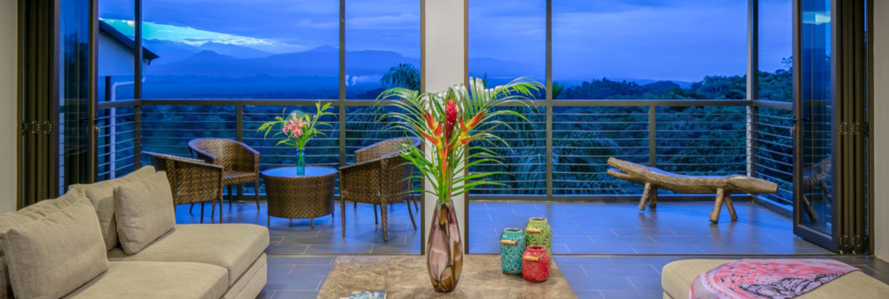 View the high mountain peaks at dusk right from the main living area in the Casa Querencia.