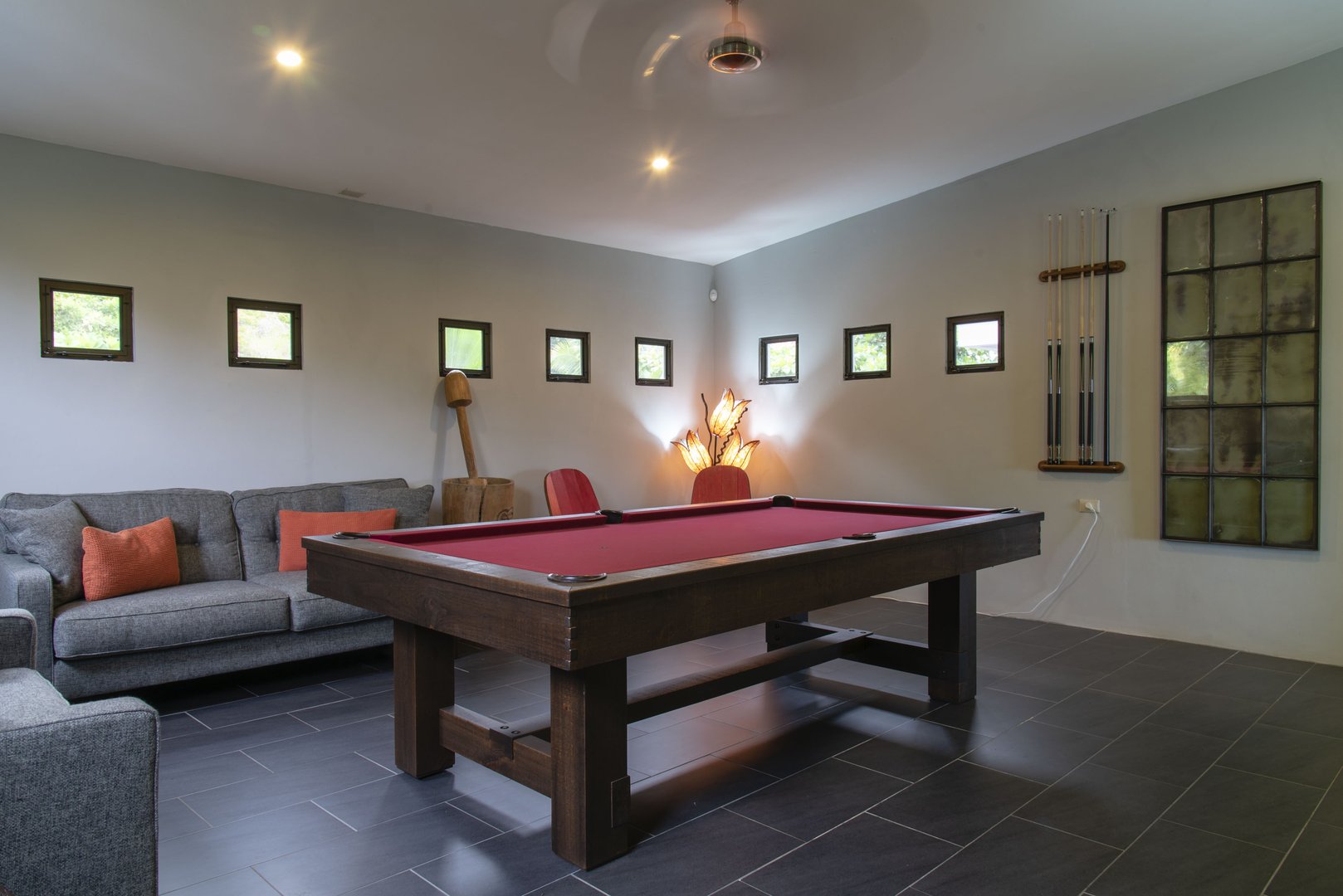 The game room has a sitting area and an awesome pool table to enjoy on your Manuel Antonio vacation.
