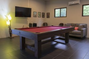 Another great feature of the games room is the wall-mounted television so you can watch your favorite show while playing pool or relaxing on the comfortable furniture.