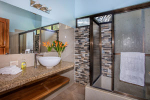 This guest bath features a full size shower and plenty of counter space.